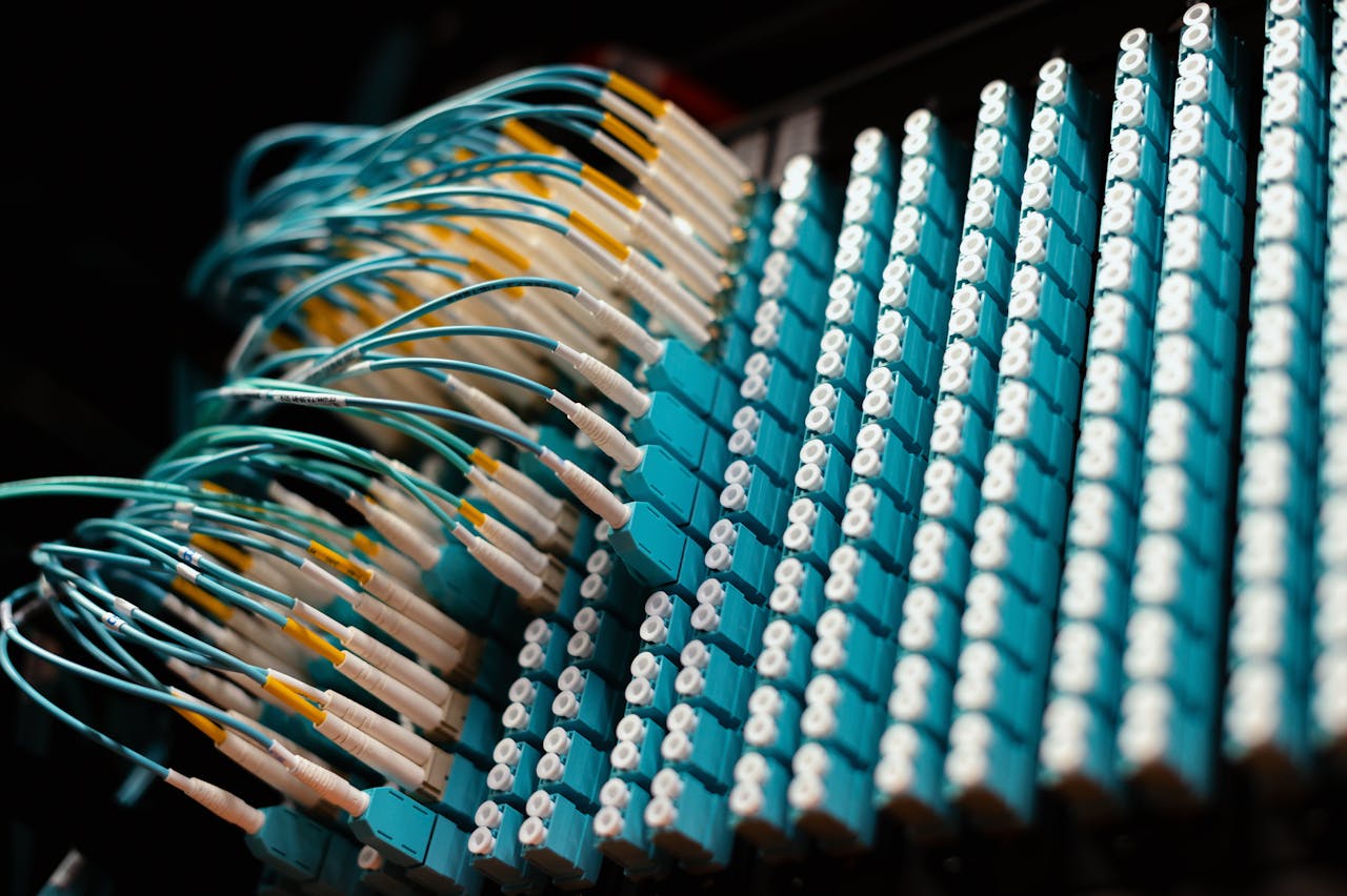 Close-up view of organized fiber optic cables on a patch panel, showing efficient cable management.